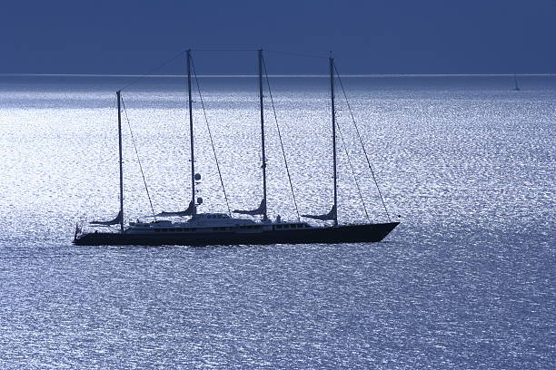 Hydra Island, Greece - October 17, 2018: a beautiful sailing ship glides over the Aegean Sea, carrying tourists on a clear day, leaving from the harbor at Hydra Island.