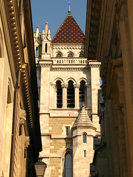 A clock tower of a roman Catholic church in Austria, blue sky with clouds at the background.