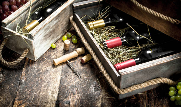 istock Wine background. Bottles of red and white wine in old boxes. 904044322