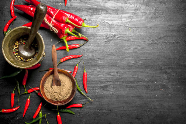 istock Grain of hot pepper in a mortar with a pestle. 904045056