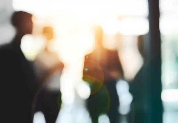 Defocused shot of a group of businesspeople having a discussion in an office