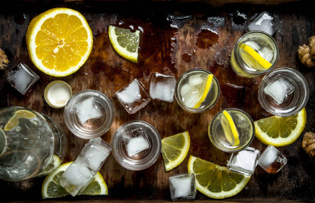 istock Vodka with lemon and ice on a wooden tray. 904056450