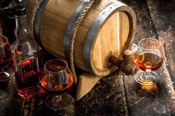 istock barrel with a long cognac and glasses. 904063646