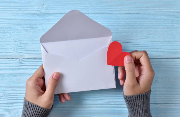 istock Female hands holding a love letter. 904063950