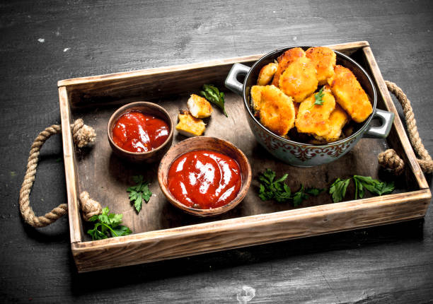 Nuggets from chicken meat with sauces on a tray. Nuggets from chicken meat with sauces on a tray. On the black chalkboard. heathy snack stock pictures, royalty-free photos & images