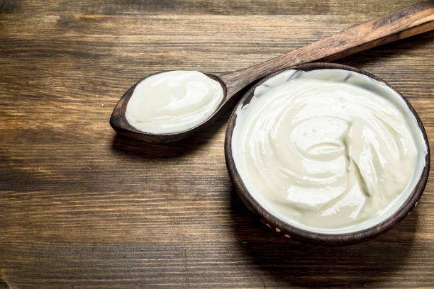 istock Natural yogurt in a bowl with a spoon. 904069160