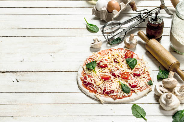istock Preparation of pizza with various ingredients. 904069508