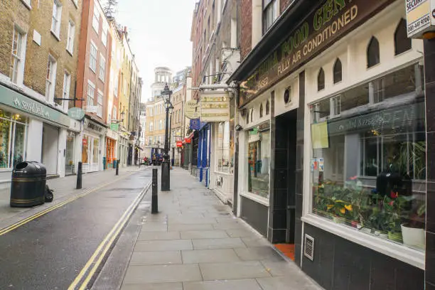 Shoreditch / London - 16 November 2017: Editorial neat and clean sidewalk with vintage shop in the morning