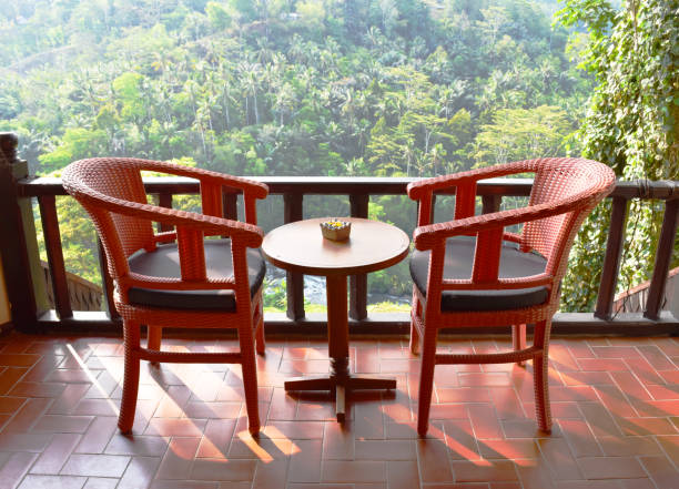 istock Two chairs on the balcony, view of tropical trees 904072774
