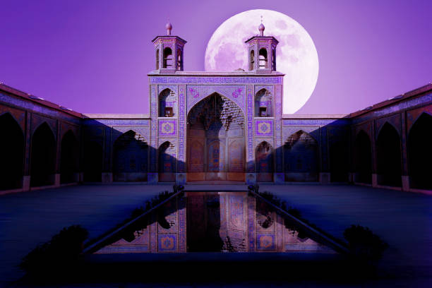 Colorful Mosque Nasir al Mulk in Shiraz. Reflection in water. Ultra violet artistic image. Colorful Mosque Nasir al Mulk in Shiraz. Reflection in water. Ultra violet artistic image. persian pottery stock pictures, royalty-free photos & images