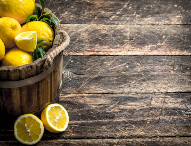 istock Fresh lemons in a wooden bucket. 904073688