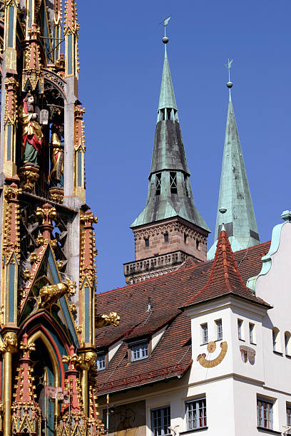 view from the marketplace to the towers of the Sebaldus church in Nuremberg, on the left a part of the Schoener Brunnen