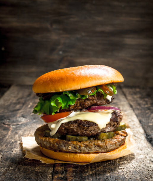 istock Big burger with beef, tomatoes and greens. 904077830