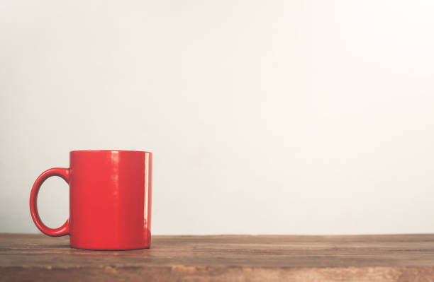 istock Red coffee mug on a wood. 904077872