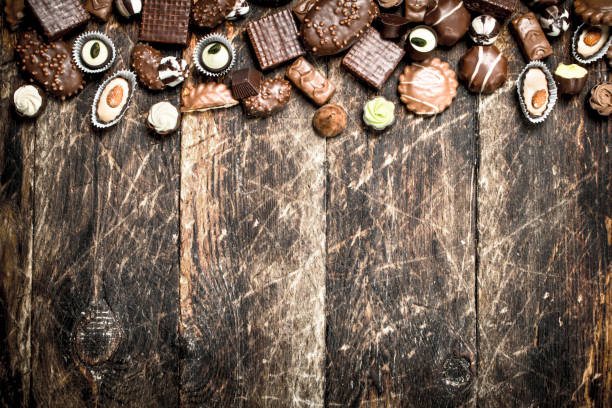 istock Chocolate candies. On wooden background. 904078960