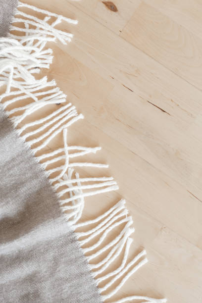istock warm wool throw plaid on wooden background 904078970