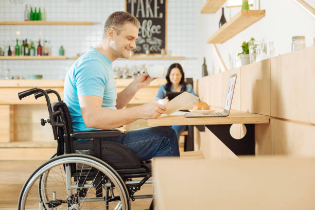 istock Inspired handicapped man working from a cafe 904079626