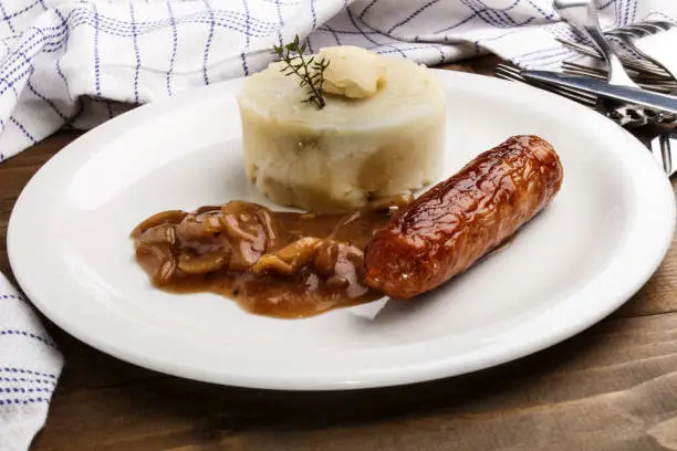 Photo of banger and mash with some irish butter on a plate