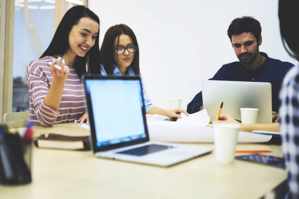 istock Young students enjoying preparation for examinations in college together having fun and talking while learning new information,smiling female employee satisfied with working task consulting with coach 904082830