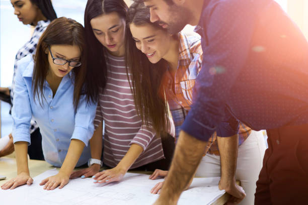 istock Crew of skilled engineers having brainstorming session in office and analyzing information for startup project,group of international students of college teamworking on  upcoming coursework indoors 904082894
