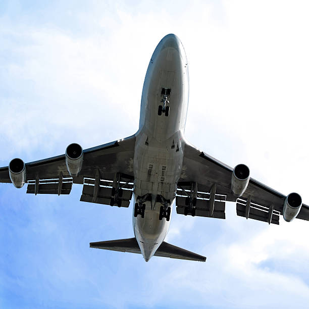 istock jumbo jet airplane landing in bright sky 90408831