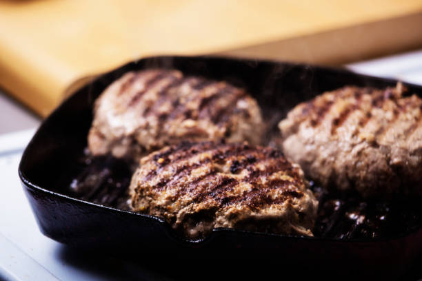 Coocked beef hamburger patties in a pan