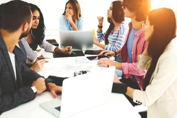 istock Young talented students of college wearing casual outfit sharing ideas about coursework planning working process and making research via modern laptop using wireless connection to internet in office 904097962