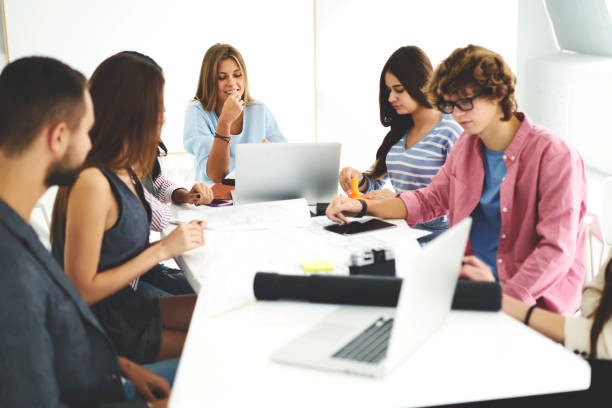 istock Young skilled staff members having conference meeting with female executive manager analyzing working achievements using application on laptop, colleagues sharing opinions on brainstorming session 904098170