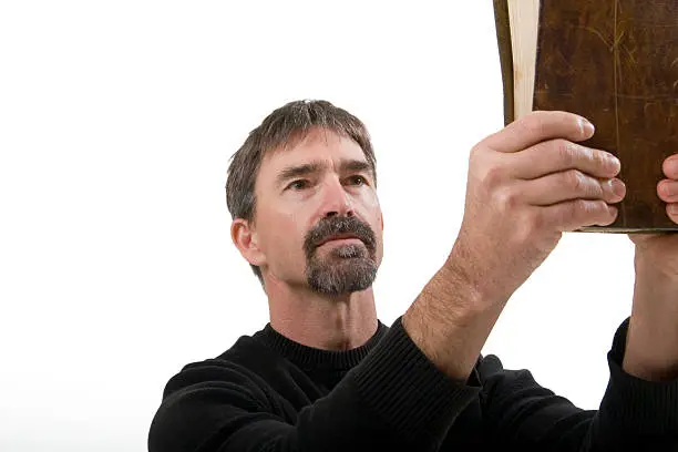 Photo of Clergyman holding up the Bible