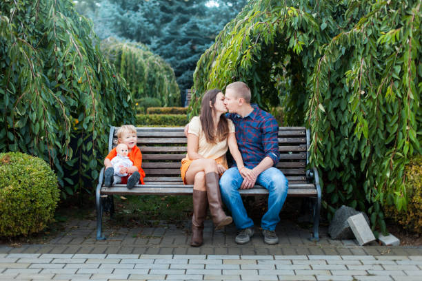 istock Dad, mom and daughter on the bench. 904098734