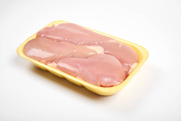 istock Raw chicken fillet package isolated on white background. 904102034