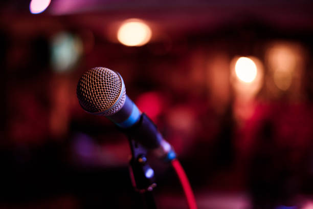 istock microphone against and music notes blur colorful light background 904102610