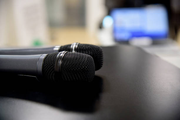 istock microphone against and music notes blur colorful light background 904102772