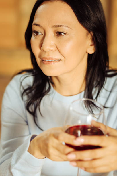 istock Concentrated woman relaxing and drinking wine 904102974