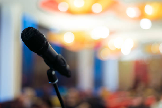 istock microphone against and music notes blur colorful light background 904103316