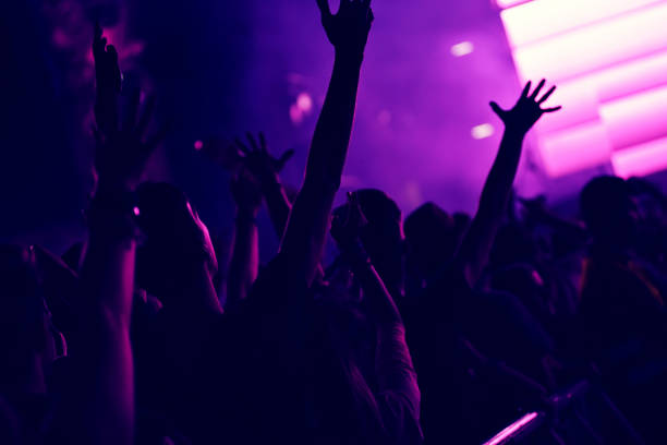 istock Crowd rocking during a concert with raised arms. 904106112