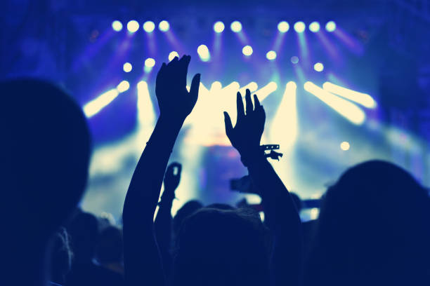 istock Crowd with arms outstretched at concert 904106128