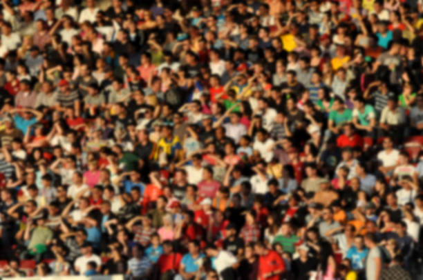 Blurred crowd of spectators in a stadium Blurred crowd of spectators in a stadium 11904 stock pictures, royalty-free photos & images