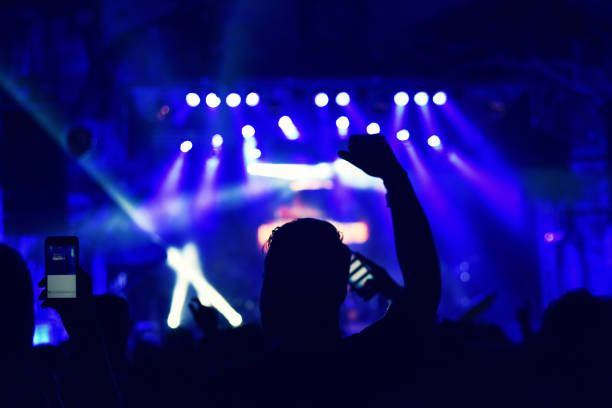 istock Crowd rocking during a concert with raised arms. 904106146