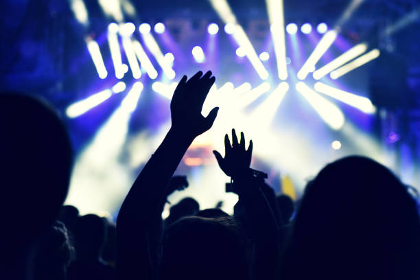 istock Crowd rocking during a concert with raised arms. 904106158