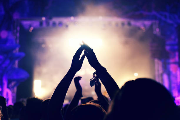 istock Crowd rocking during a concert with raised arms. 904106176