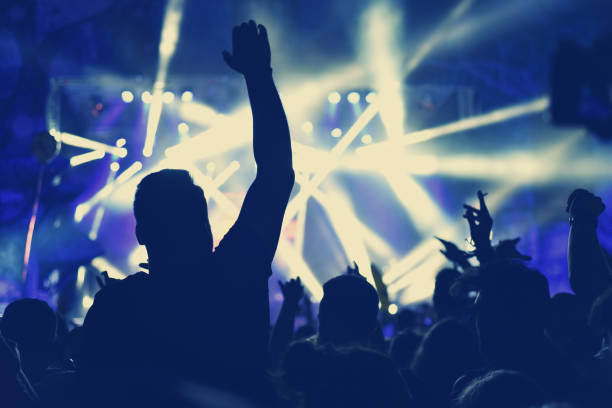 istock Crowd with arms outstretched at concert 904106184