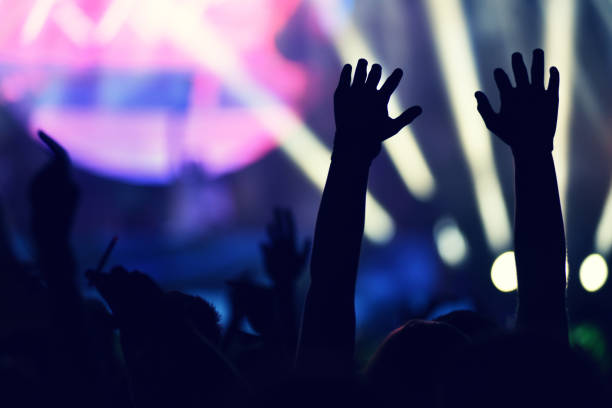 istock Crowd rocking during a concert with raised arms. 904106188