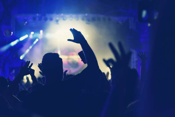 istock Crowd with arms outstretched at concert 904106228