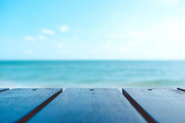 istock Wooden table with the sea and blue sky background 904106444