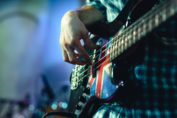 istock closeup rockstar on stage playing on electro guitar. Male guitarist 904106452