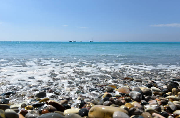 istock Beach with pebble stones and beautiful tropical sea 904106864