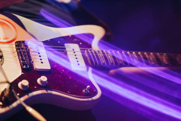 istock closeup rockstar on stage playing on electro guitar. Male guitarist 904106890