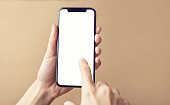 Close up hand holding black smartphone on white clipping path inside
