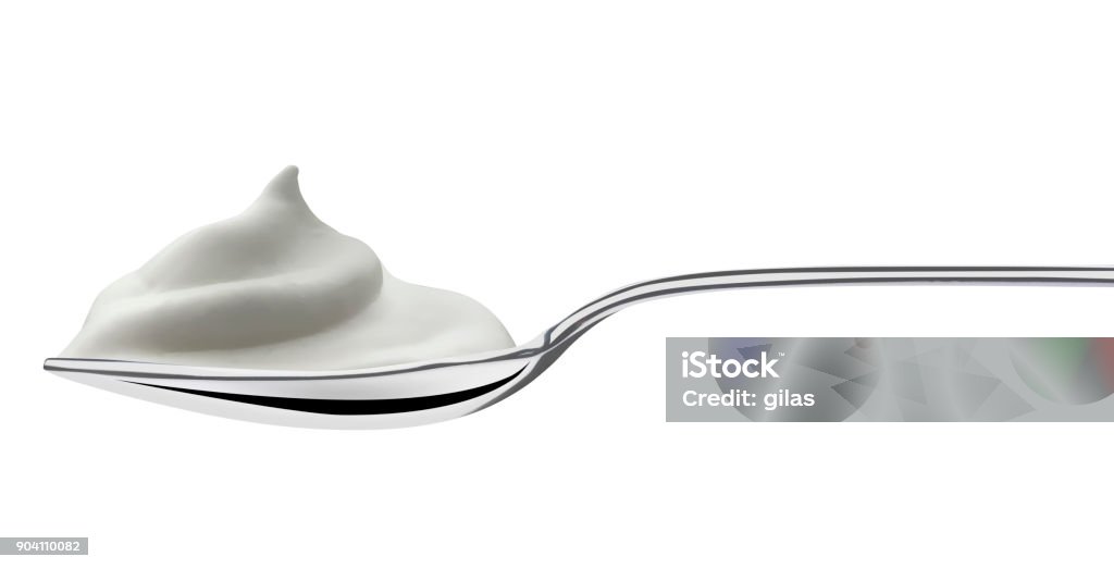 spoon filled of milk cream steel spoon filled of milk cream, isolated on white Yogurt Stock Photo